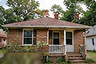 Brick bungalow with a covered porch